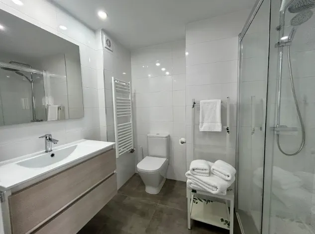 Bathroom with vanity unit, toilet and shower