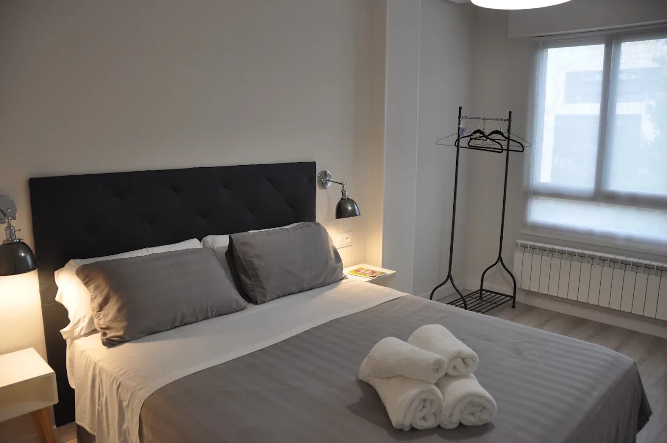 Bedroom with fresh towels and clothes rail